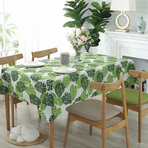 Nordic cotton linen tablecloth with green monstera leaf print on rectangular table