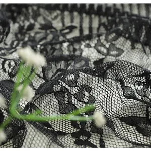 Detailed macro view of vintage black lace tablecloth with delicate floral patterns