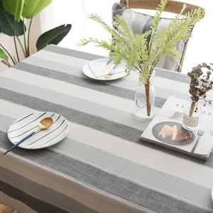 Detail of grey striped waterproof tablecloth with high-quality linen texture for modern dining