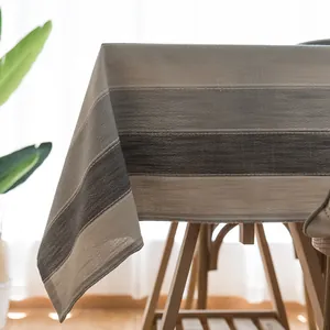 Detail of Nordic striped waterproof tablecloth showing grey gradient texture and drape