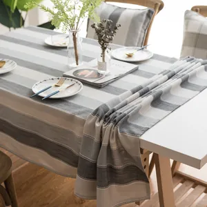 Close-up of modern waterproof striped tablecloth with grey and beige textured linen fabric