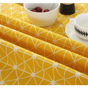 Close-up of yellow cotton linen tablecloth with white geometric patterns and home decor