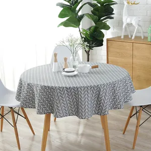 Detail of grey arrow pattern on a round cotton linen tablecloth with elegant drape