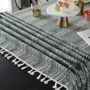 Bohemian striped tablecloth with green and beige geometric patterns and white fringe