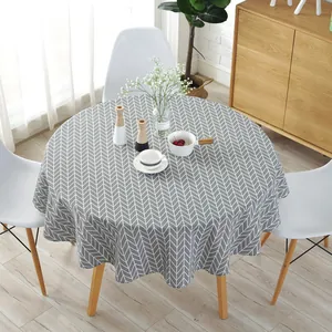 Nordic style grey and white herringbone pattern round tablecloth on a wooden table