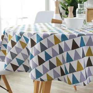 Detail of round cotton linen tablecloth with colorful geometric triangle pattern print