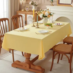 Macro view of bright yellow linen textured tablecloth with elegant draped edges