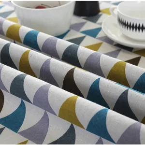 Close-up of cotton linen tablecloth showing soft geometric pattern texture and fabric drape