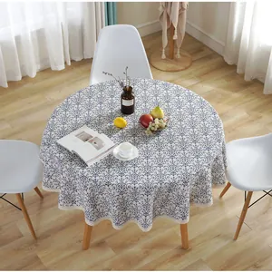 Round cotton linen tablecloth with blue floral pattern and white lace edge in home setting