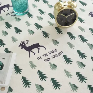Macro detail of Nordic forest pattern cotton linen tablecloth with deer and pine tree print