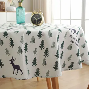 Close-up of Nordic round tablecloth with pine trees and elk print on cotton linen fabric