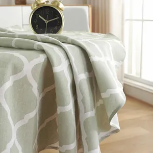 Close-up of green cotton linen tablecloth showing soft drape and Moroccan geometric pattern