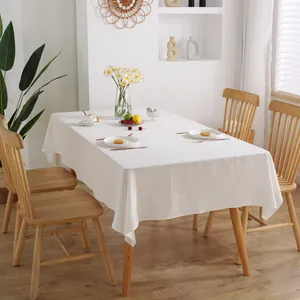 Close-up of minimalist white cotton rectangular tablecloth with fine wrinkled texture