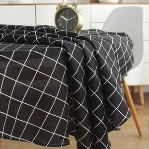 Detailed view of black and white checkered cotton linen tablecloth with fabric texture