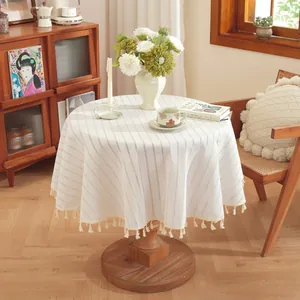 Modern minimalist round cotton linen tablecloth with striped texture and tassel trim