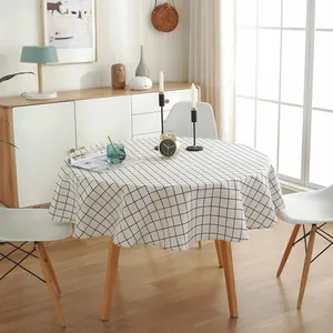 Nordic style round tablecloth with classic black and white grid pattern on a wooden table