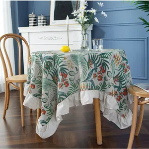 Vintage round tablecloth with tropical plant print and elegant ruffled edges for dining