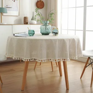 Nappe ronde minimaliste en lin beige avec d'élégantes franges en coton blanc raffiné