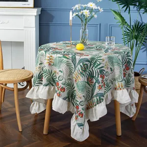 Macro detail of tropical leaf print on round tablecloth with ruffled edge design