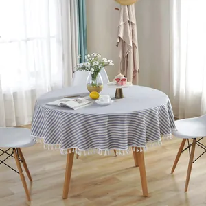 Close-up of blue and white striped round tablecloth featuring detailed white fringe edges