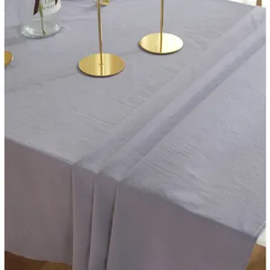 Detail of gray cotton tablecloth with natural texture and fine stitching on the edges
