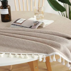 Minimalistisch beige waterdicht rond linnen tafelkleed met witte kwastjes