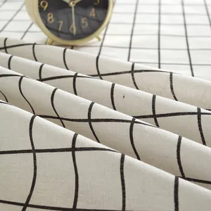 Detailed texture of black and white checkered cotton linen fabric with vintage gold clock