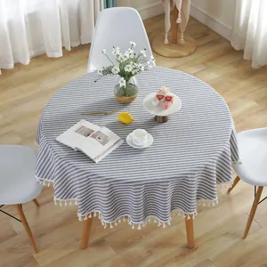 Close-up of round blue and white striped cotton linen tablecloth with fringe edges