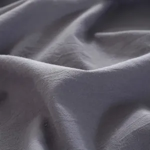 Close-up of premium grey washed cotton tablecloth showing natural texture and soft drapes