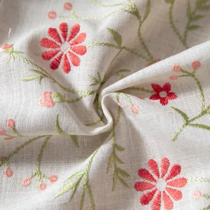 Detailed view of grey cotton linen tablecloth with red floral embroidery and green leaves