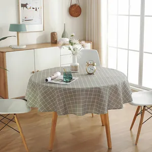 Detailed view of grey and white checkered linen tablecloth on round dining table