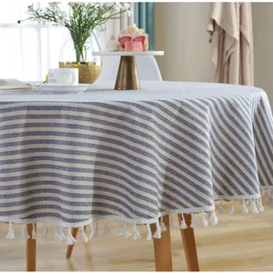 Close-up of blue and white striped round tablecloth with elegant tassel fringe detail