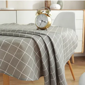 Close-up of gray Nordic checkered linen tablecloth showing fabric texture and neat stitching