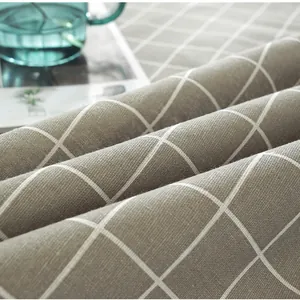 Macro view of Nordic style cotton linen tablecloth featuring a grey and white plaid pattern