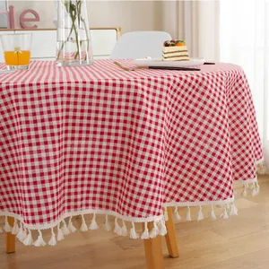 Close-up of pink checkered tablecloth fabric with elegant white tassel fringe edges