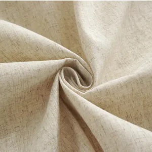 Macro shot of natural linen fabric texture with rustic tassel and oatmeal color detail