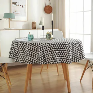 Detail of round black and white geometric tablecloth in cotton linen with natural drape