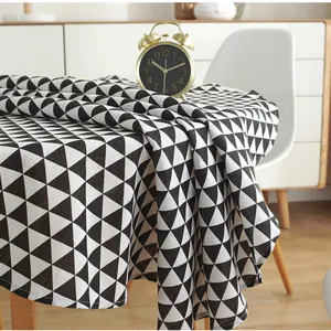 Detailed close-up of cotton linen tablecloth featuring black and white geometric triangles