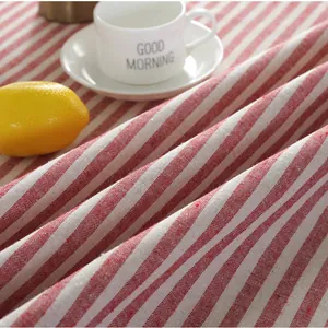 Detail of red and white striped linen tablecloth with natural texture and soft folds