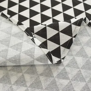Detail of minimalist black and white geometric triangle pattern fabric with neat edge stitching
