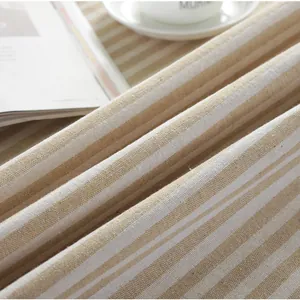 Close-up of beige and white striped cotton linen fabric texture with a coffee cup