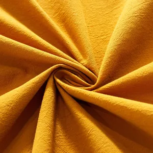 Macro detail of ginger yellow crinkle texture fabric with a spiral pleated design