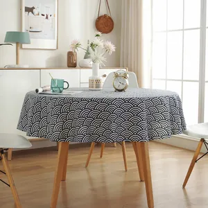Macro detail of round linen tablecloth featuring classic blue and white Seigaiha ocean waves