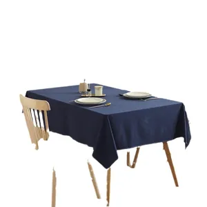 Minimalist navy blue cotton rectangular tablecloth on a wooden table with dining decor