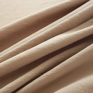 Close-up of beige linen fabric texture showing interwoven fibers and soft drape detail