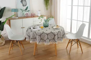 Detail of gray mandala round tablecloth with boho tassels and Nordic cotton texture