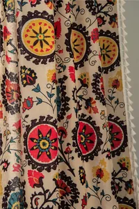 Detail of bohemian sunflower cotton linen curtain featuring vibrant prints and white tassels
