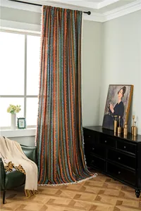 Macro detail of Bohemian cotton linen curtain with colorful stripes and white tassel trim