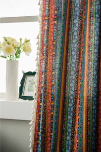 Detailed view of bohemian cotton linen curtains with colorful stripes and white tassels