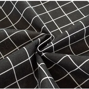 Macro view of black and white windowpane plaid cotton linen fabric with soft drape